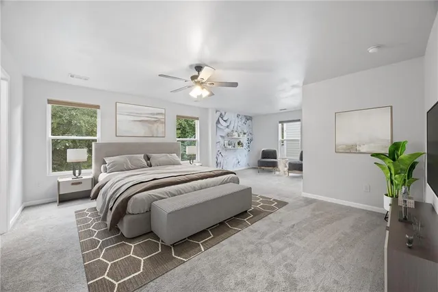 a spacious bedroom with a bed and a chandelier