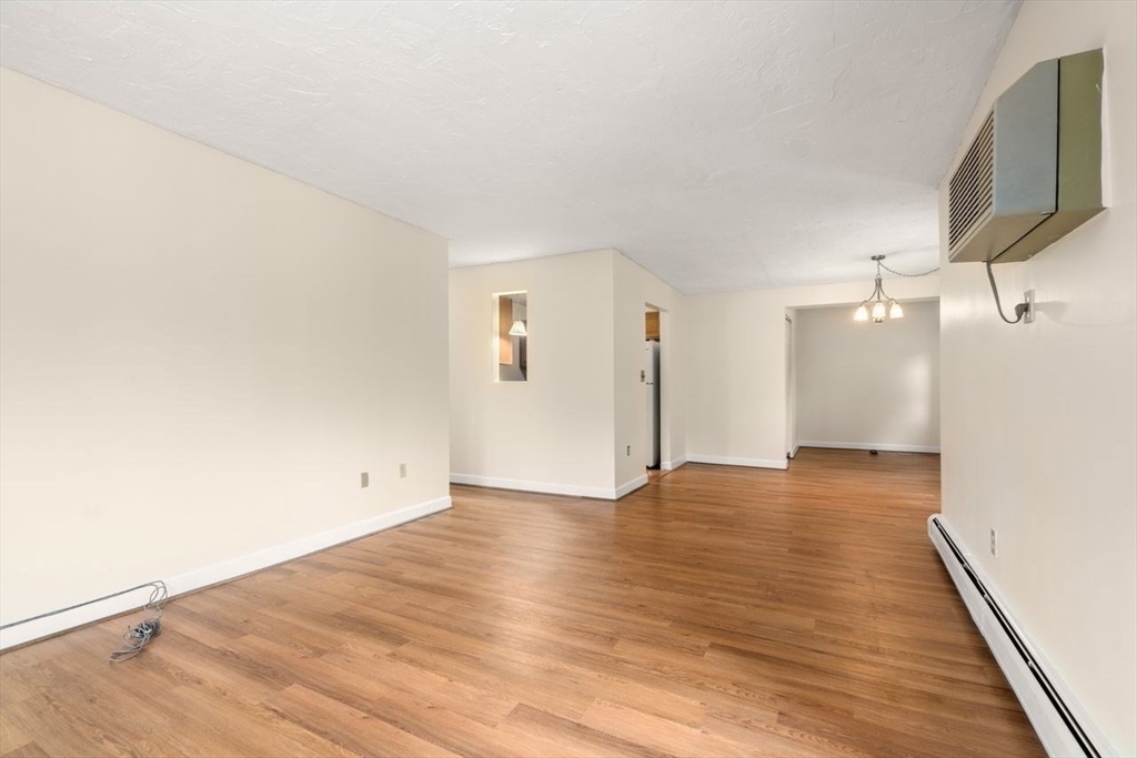 16 Winter Street, Unit 41C Waltham, MA 02451 - Photo 14 of 25 a view of an empty room with wooden floor