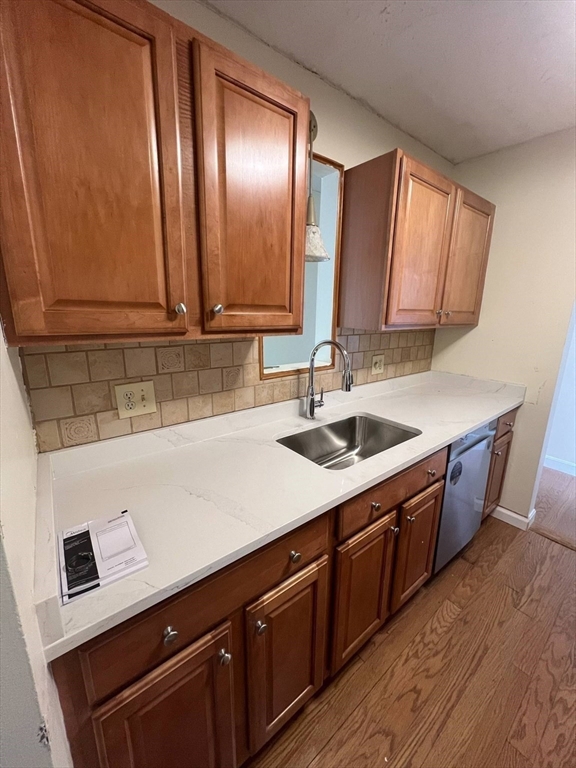 16 Winter Street, Unit 41C Waltham, MA 02451 - Photo 2 of 25 a kitchen with a sink cabinets and wooden floor