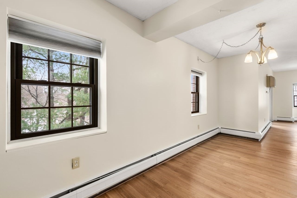 16 Winter Street, Unit 41C Waltham, MA 02451 - Photo 6 of 25 a view of an empty room with wooden floor and a window