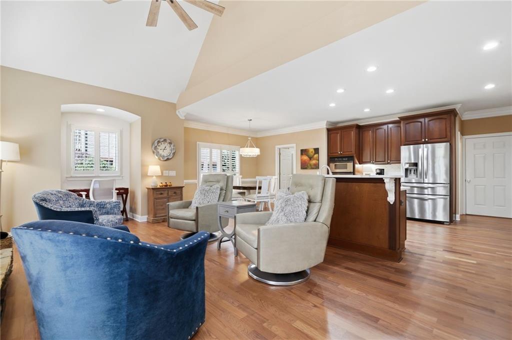 4147 Gold Mill Ridge Canton, GA 30114 - Photo 19 of 93 a living room with stainless steel appliances kitchen island granite countertop a table chairs and a refrigerator