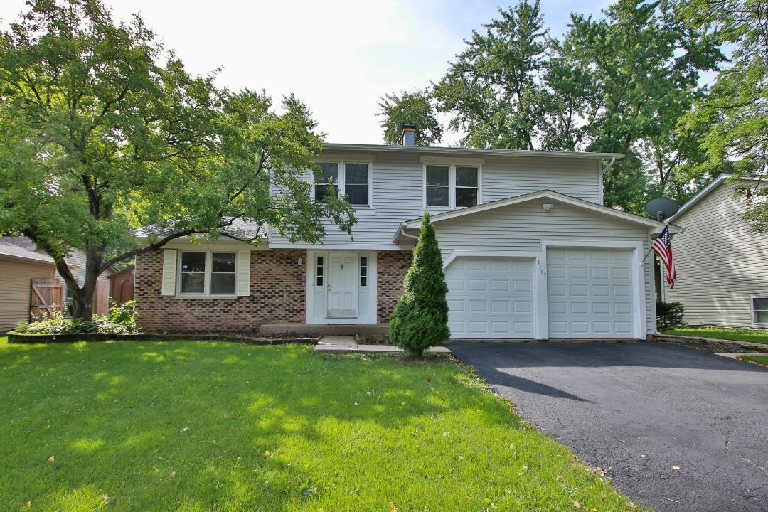 a front view of house with yard and trees