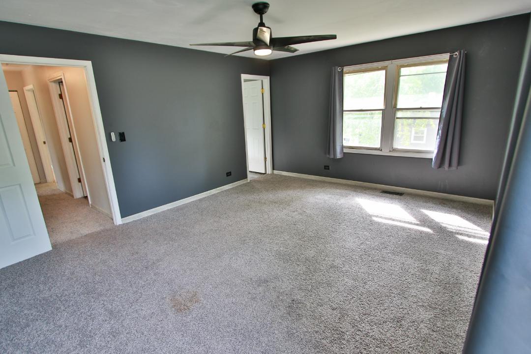 1189 Cumberland Road Aurora, IL 60504 - Photo 11 of 23 an empty room with windows and chandelier fan