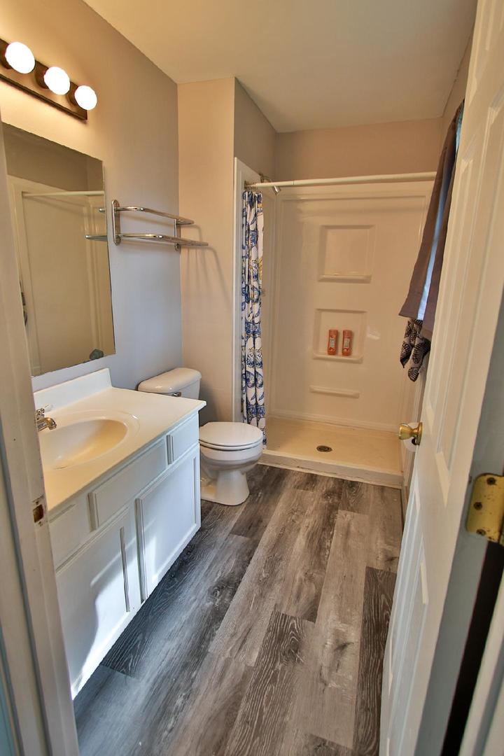 1189 Cumberland Road Aurora, IL 60504 - Photo 14 of 23 a bathroom with a sink a toilet and shower