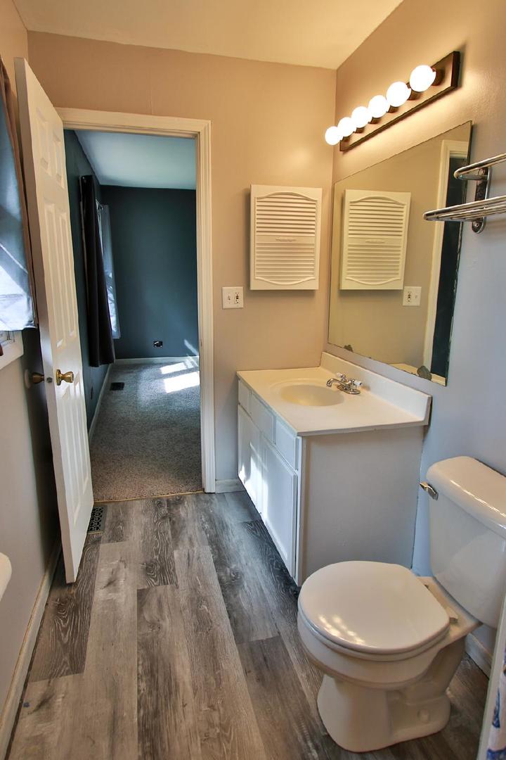 1189 Cumberland Road Aurora, IL 60504 - Photo 15 of 23 a bathroom with a sink a toilet and mirror