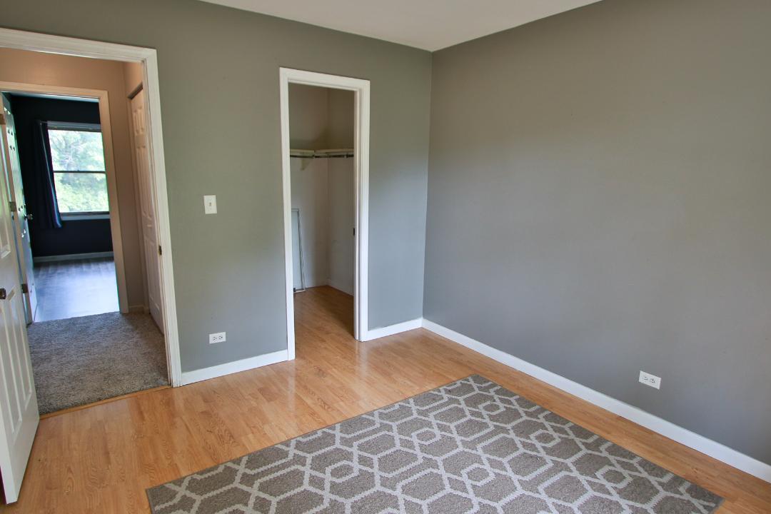 1189 Cumberland Road Aurora, IL 60504 - Photo 17 of 23 an empty room with wooden floor and closet