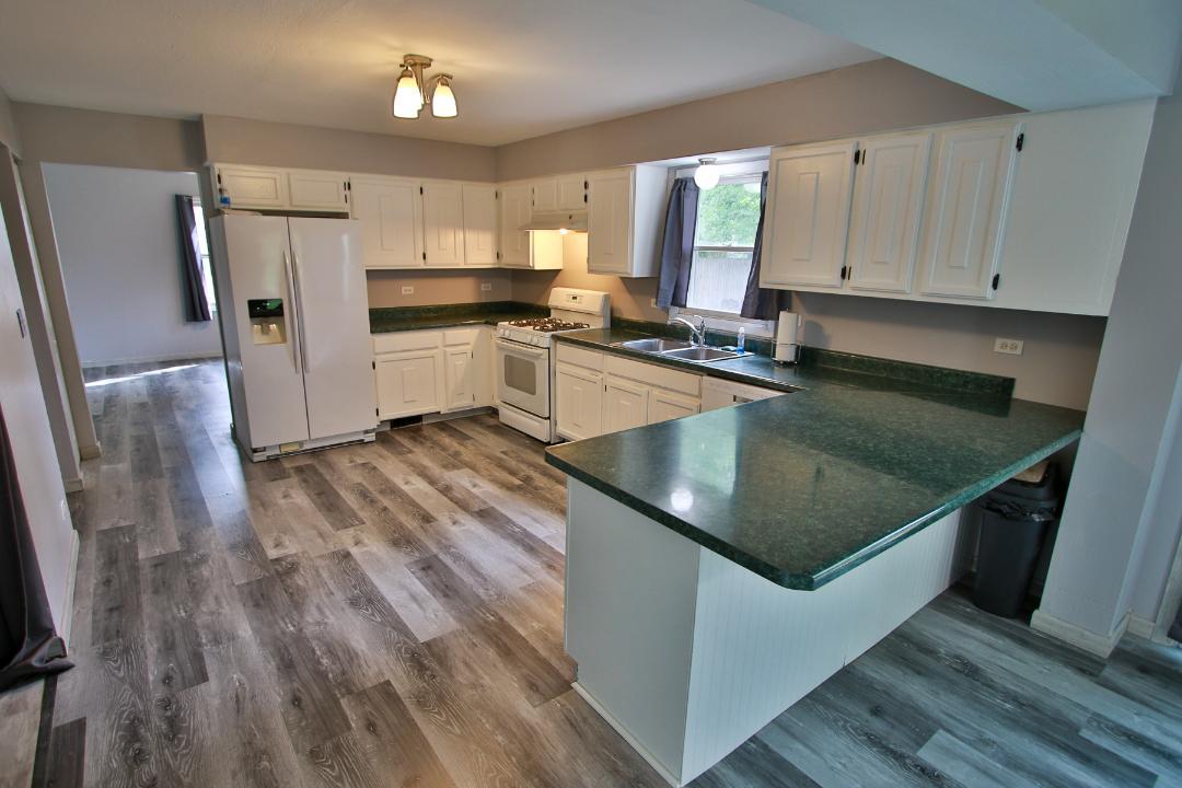 1189 Cumberland Road Aurora, IL 60504 - Photo 3 of 23 a kitchen with wooden floors a counter space and appliances