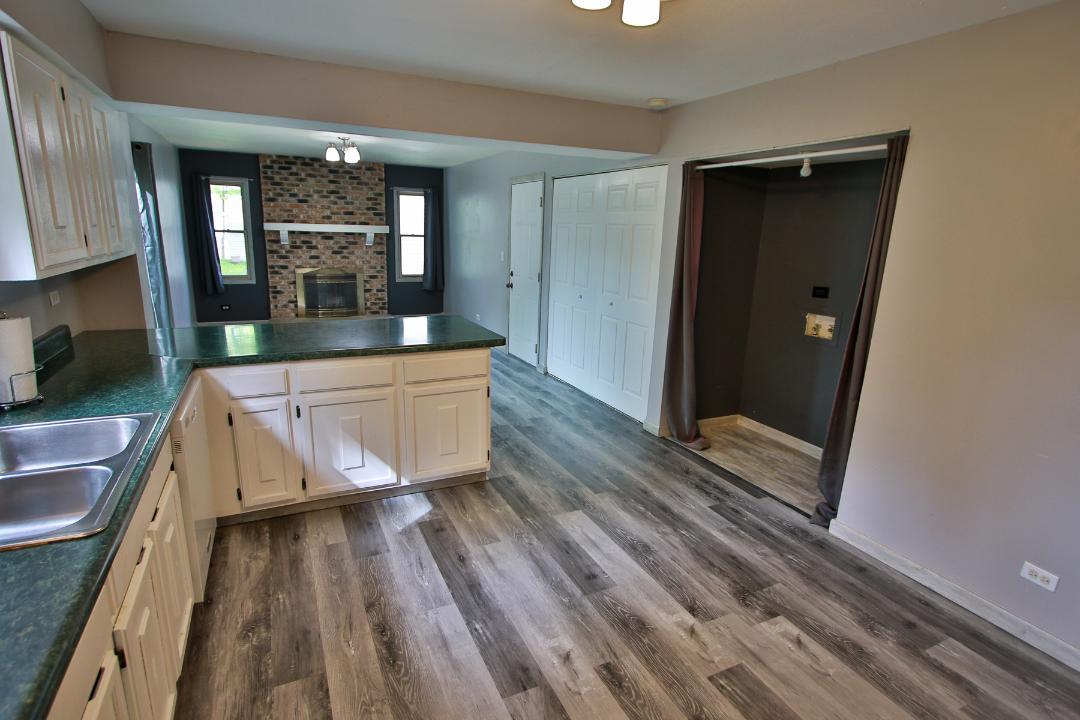 1189 Cumberland Road Aurora, IL 60504 - Photo 6 of 23 a large white kitchen with sink a refrigerator and a large window