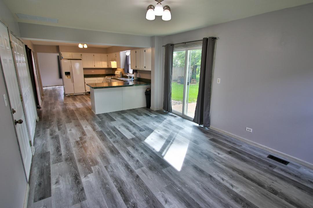 1189 Cumberland Road Aurora, IL 60504 - Photo 7 of 23 a kitchen with a refrigerator and a stove top oven