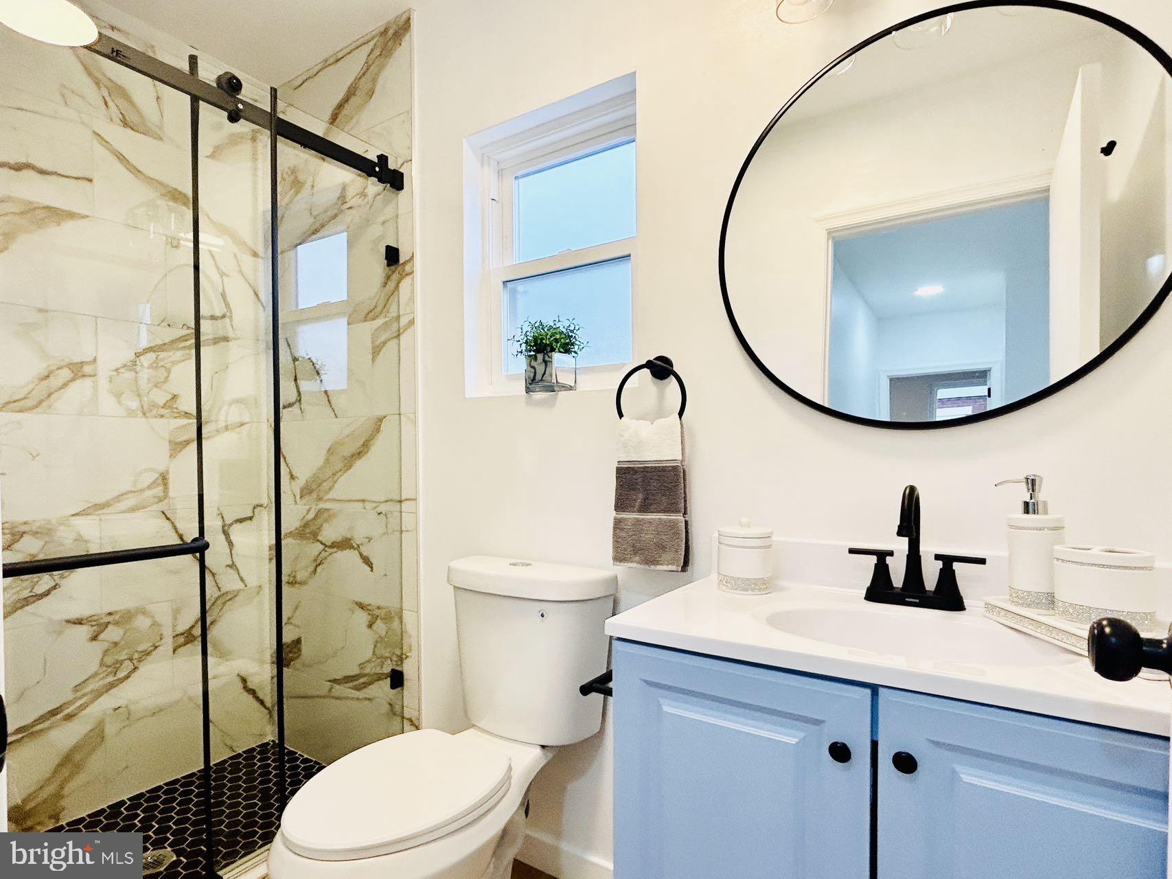 2013 South Bouvier Street Philadelphia, PA 19145 - Photo 10 of 18 a bathroom with a sink a mirror a toilet and shower