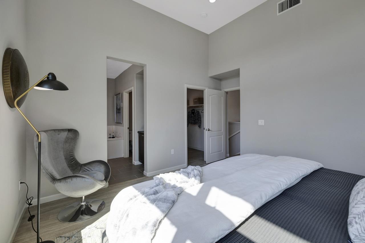3079 Manuel Loop San Jose, CA 95136 - Photo 29 of 64 a bedroom with a bed a chair and potted plant