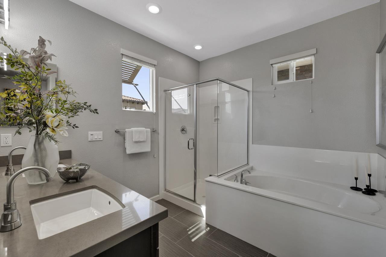 3079 Manuel Loop San Jose, CA 95136 - Photo 32 of 64 a bathroom with a tub sink and mirror