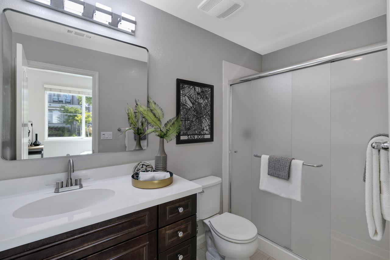 3079 Manuel Loop San Jose, CA 95136 - Photo 44 of 64 a bathroom with a granite countertop sink toilet a large mirror and shower