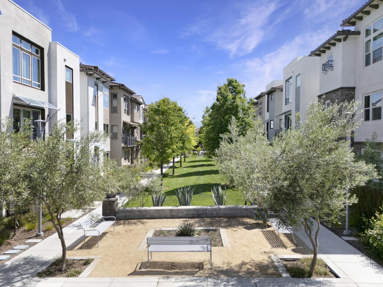 3079 Manuel Loop San Jose, CA 95136 - Photo 57 of 64 a front view of a multi story residential apartment building with a yard