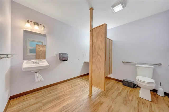 a bathroom with a toilet and a shower