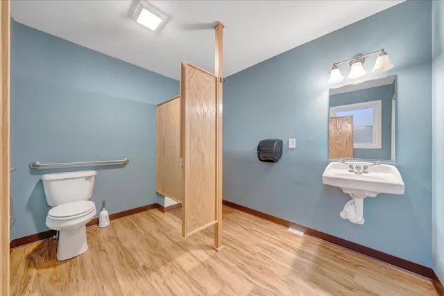a bathroom with a sink toilet and mirror
