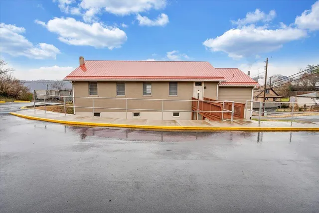 a view of a house with swimming pool and porch