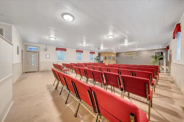 a dining room with furniture and a chandelier