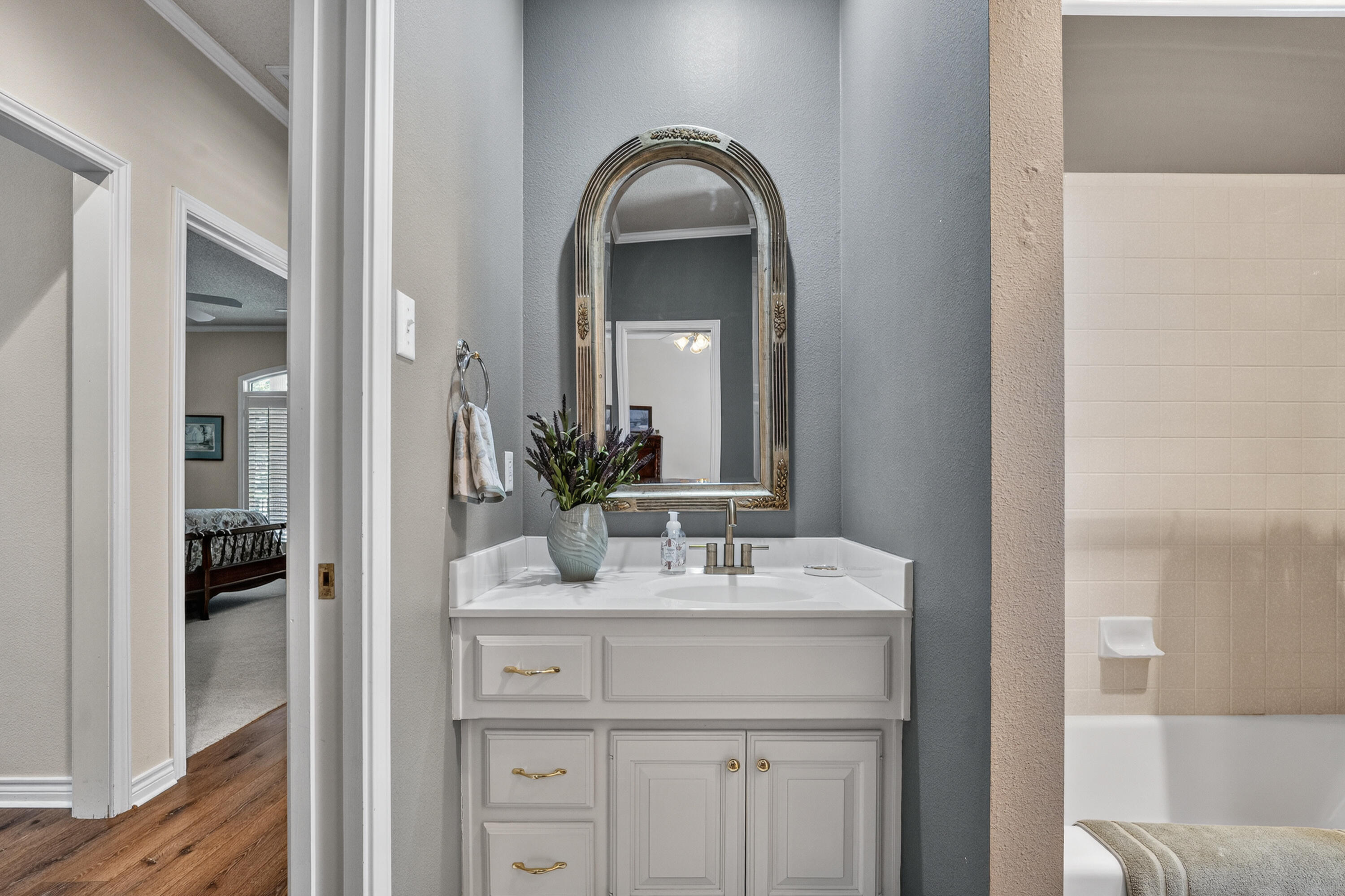 7402 95th Street Lubbock, TX 79424 - Photo 29 of 43 a bathroom with a sink and a mirror