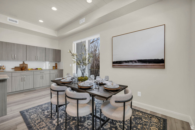 4016 South Burch Way Ogden, UT 84405 - Photo 5 of 30 Dining area featuring wood-finish flooring, a tray ceiling with recessed lighting, and a sliding glass door