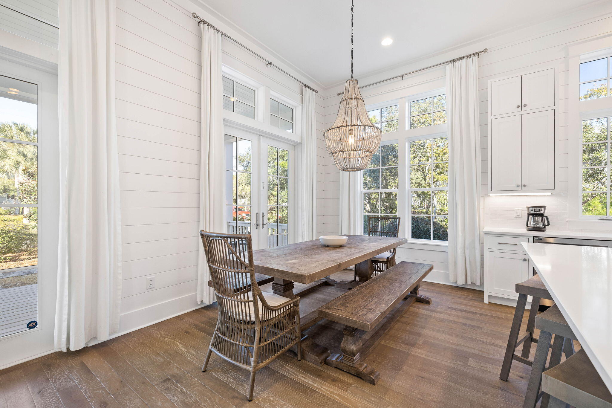 44 Seacrest Drive Inlet Beach, FL 32461 - Photo 30 of 129 a dining room with wooden floor a chandelier a wooden table and chairs