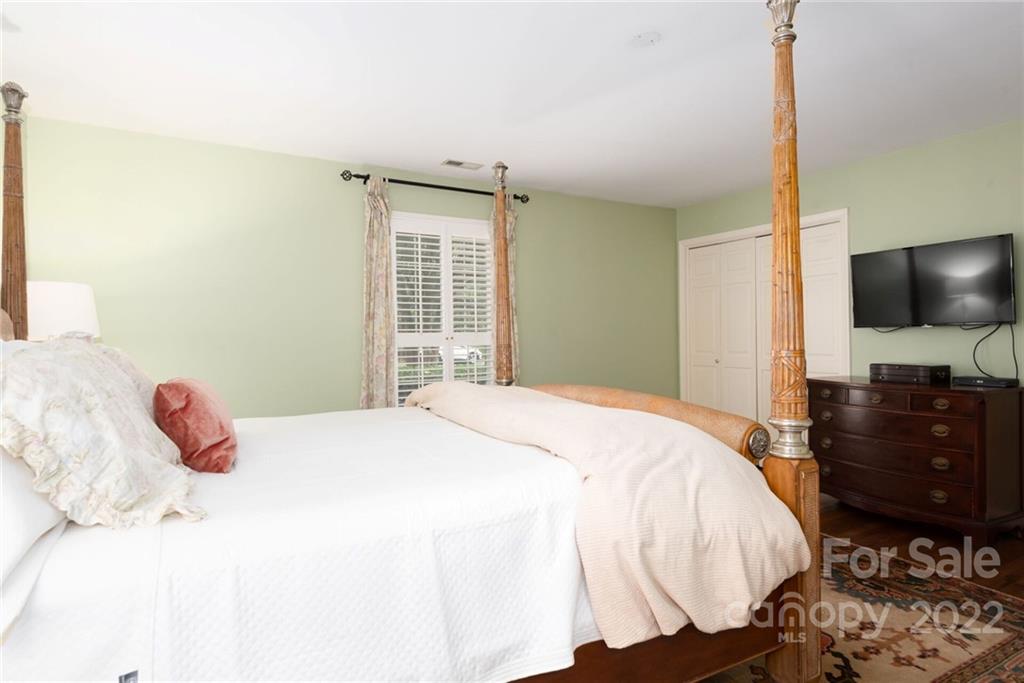 2815 Wickersham Road Charlotte, NC 28211 - Photo 20 of 34 a bedroom with a bed and flat screen tv