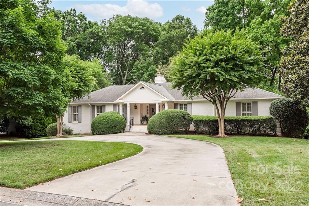 2815 Wickersham Road Charlotte, NC 28211 - Photo 2 of 34 a front view of a house with a yard and potted plants