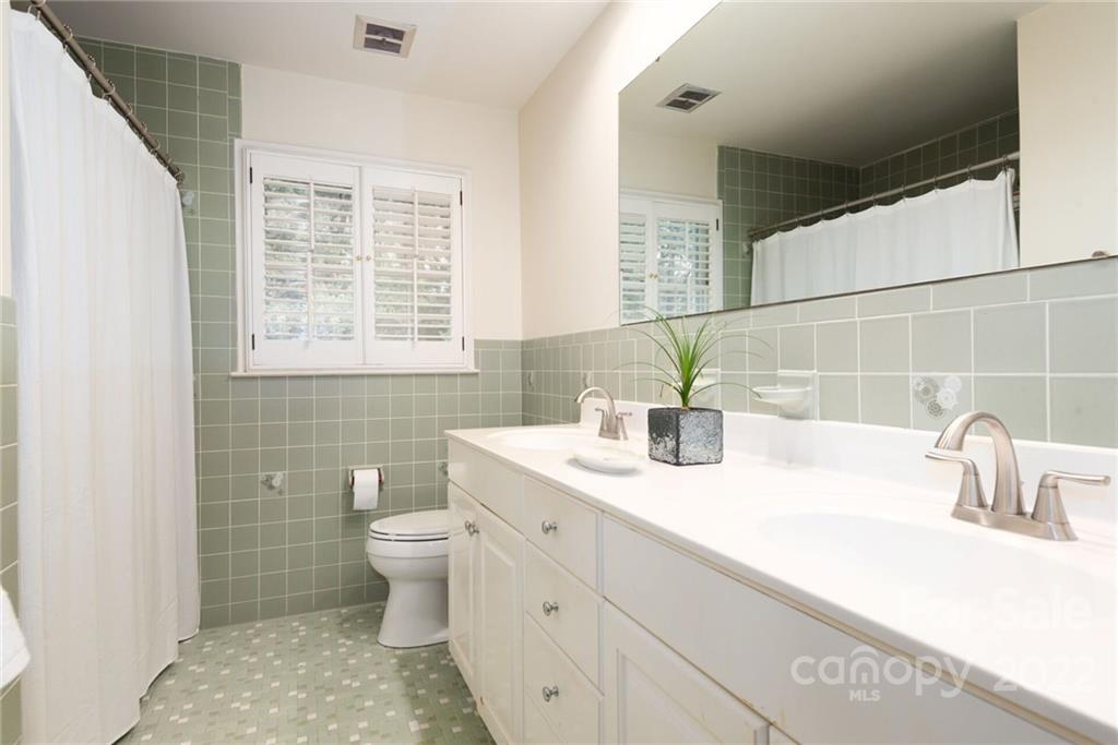 2815 Wickersham Road Charlotte, NC 28211 - Photo 21 of 34 a bathroom with a sink a toilet and a mirror