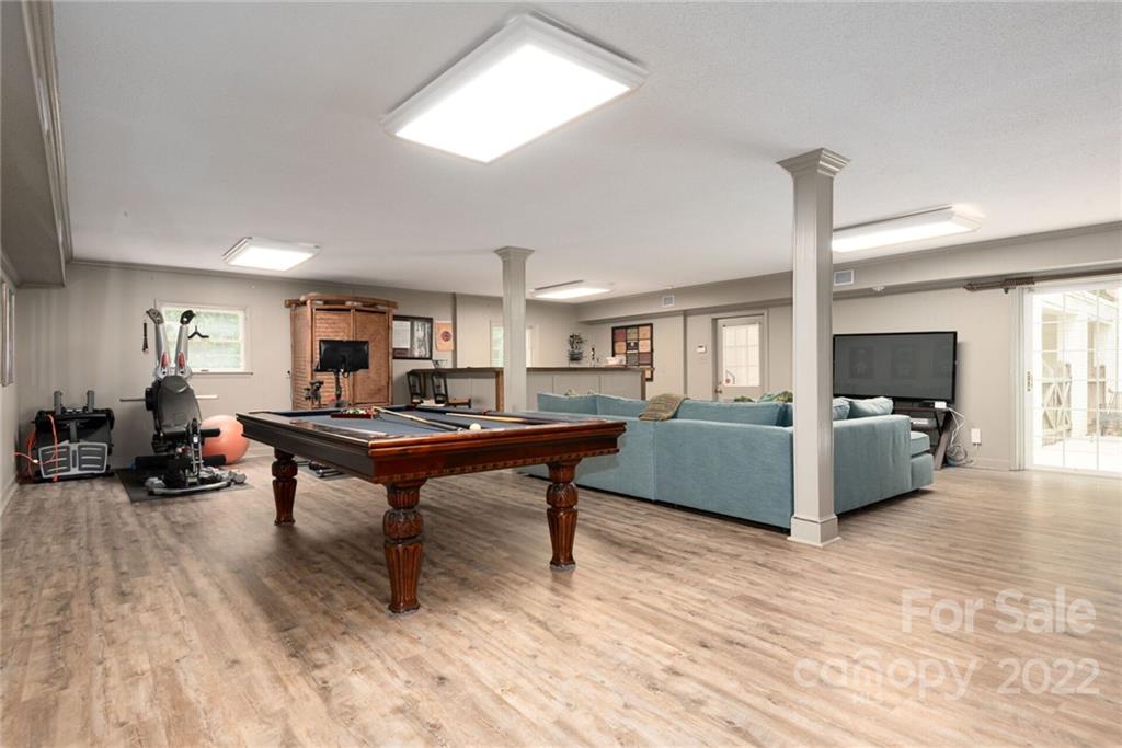 2815 Wickersham Road Charlotte, NC 28211 - Photo 25 of 34 a living room with furniture a bed and a flat screen tv