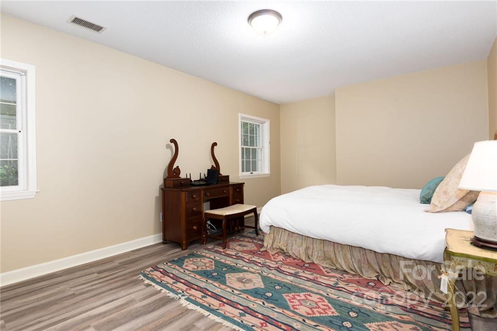 2815 Wickersham Road Charlotte, NC 28211 - Photo 26 of 34 a bedroom with a bed and wooden floor