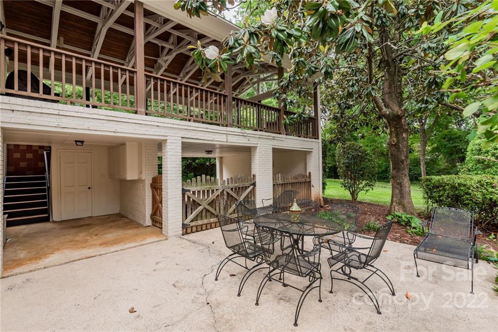 2815 Wickersham Road Charlotte, NC 28211 - Photo 30 of 34 a view of a patio with table and chairs with wooden fence and plants