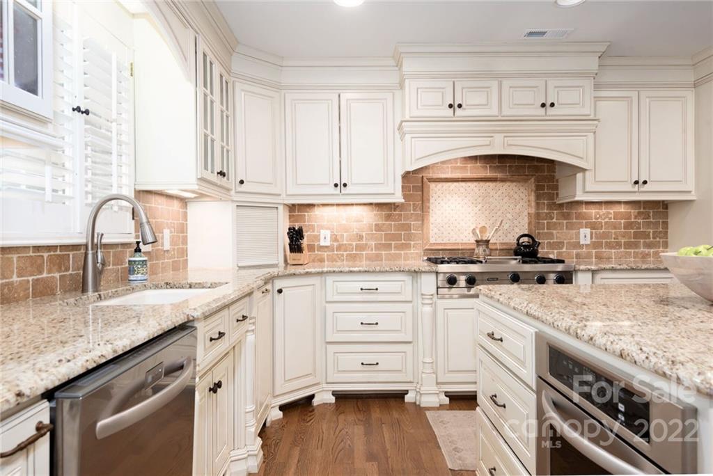 2815 Wickersham Road Charlotte, NC 28211 - Photo 8 of 34 a kitchen with granite countertop a sink stainless steel appliances and cabinets