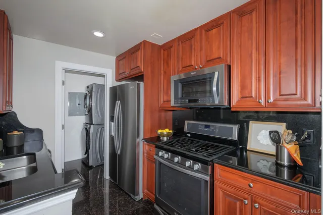 a kitchen with stainless steel appliances a stove a microwave and a refrigerator