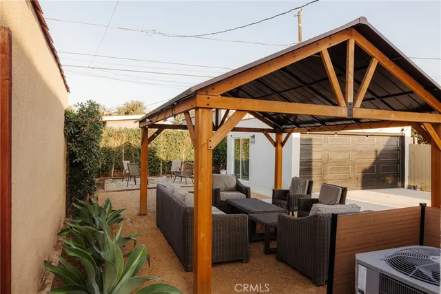 a view of a hallway with wooden floor and a bathroom