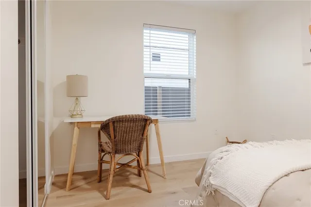 a bedroom with a bed and a wall painting