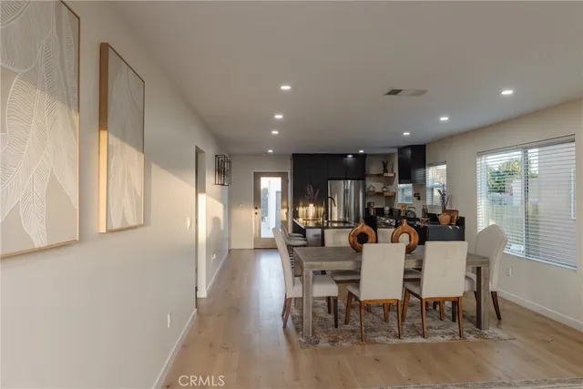 a living room with furniture and view of wooden floor
