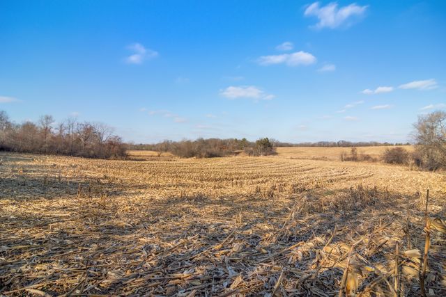 a view of a dry yard covered with snow in front of house