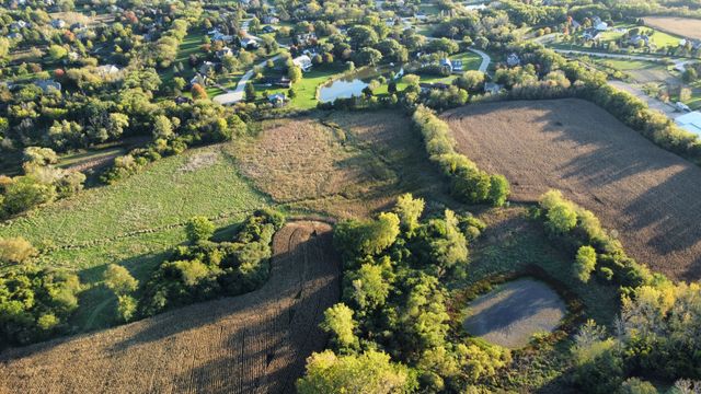 an aerial view of a houses with a yard