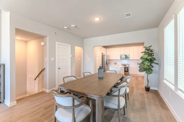 a view of a dining room with furniture window and wooden floor