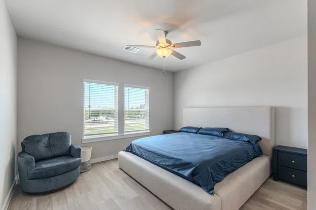 a bedroom with a large bed and a couch