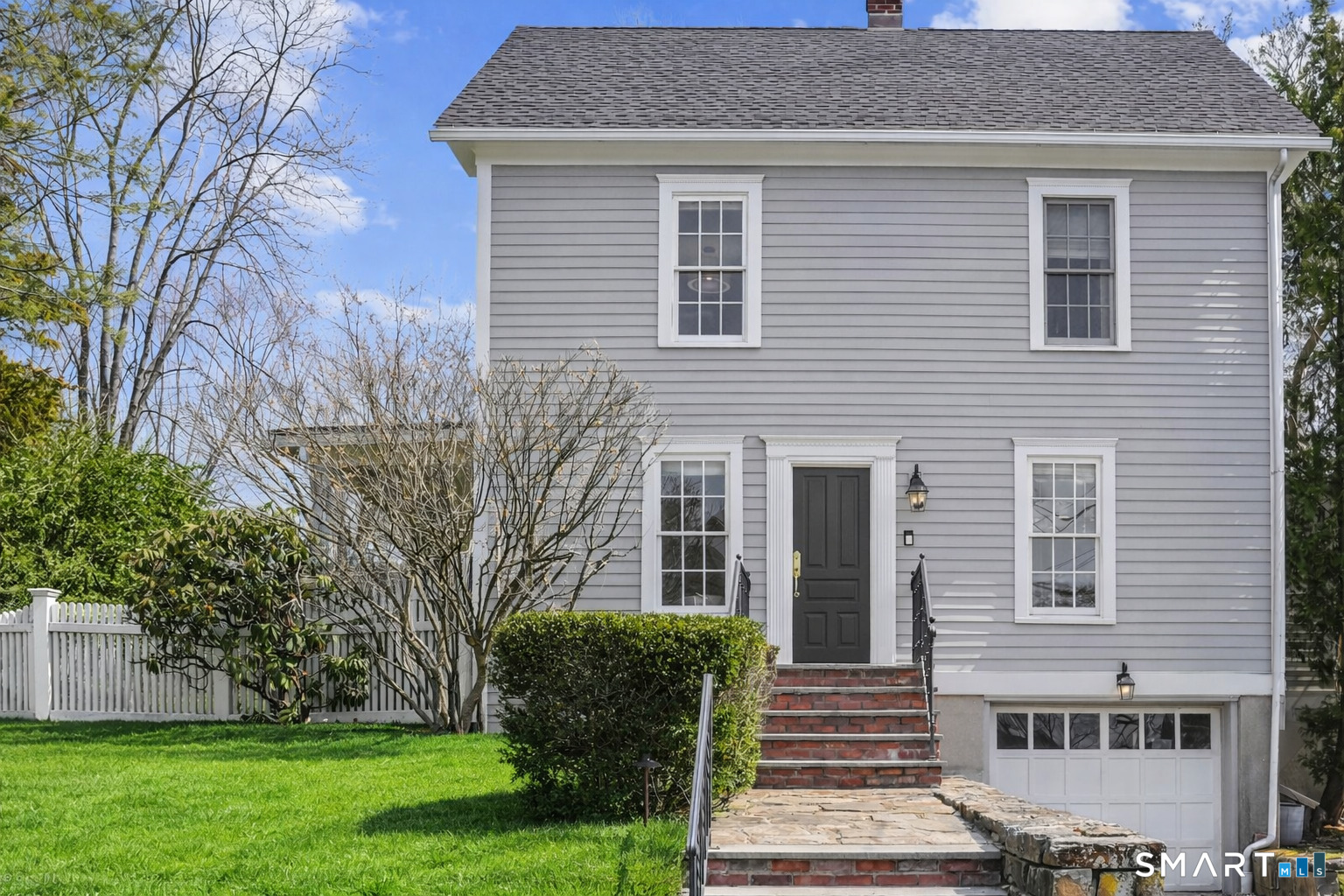26 Taylor Place Fairfield, CT 06890 - Photo 1 of 1 a front view of a house with garden