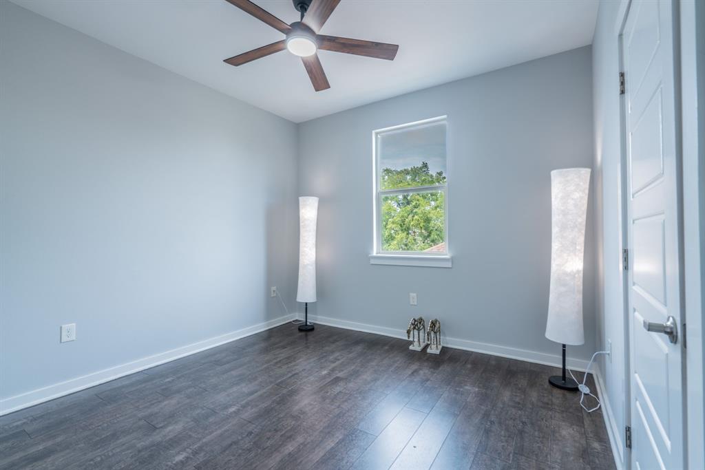 3610 Vilbig Road Dallas, TX 75212 - Photo 17 of 29 Ceiling fan with integrated lighting, wood-finish flooring, single window, and a paneled interior door