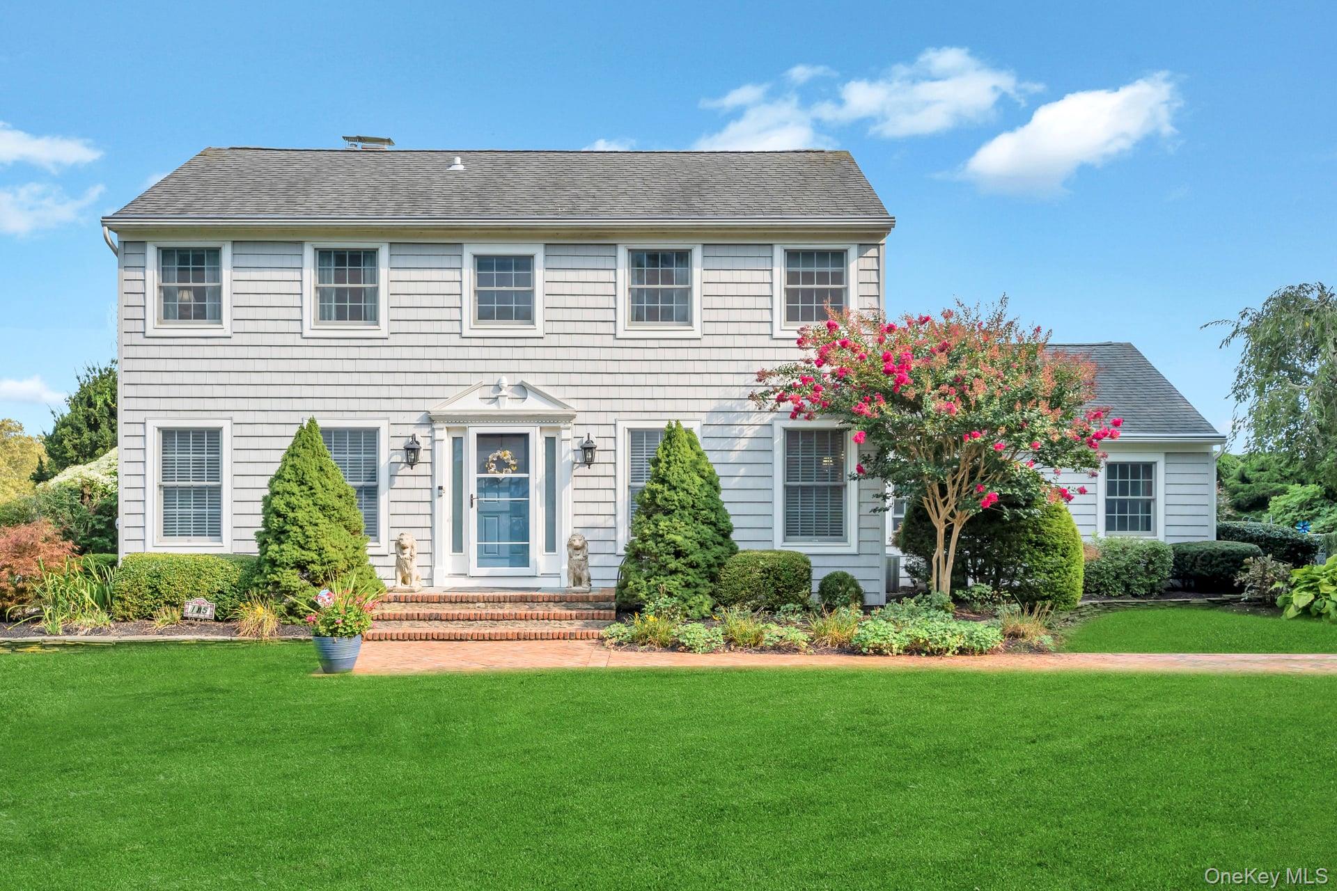 a front view of house with yard and green space