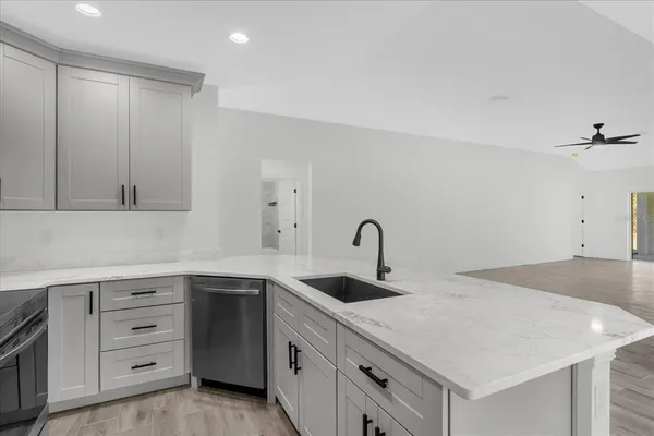 a kitchen with a sink dishwasher and cabinets