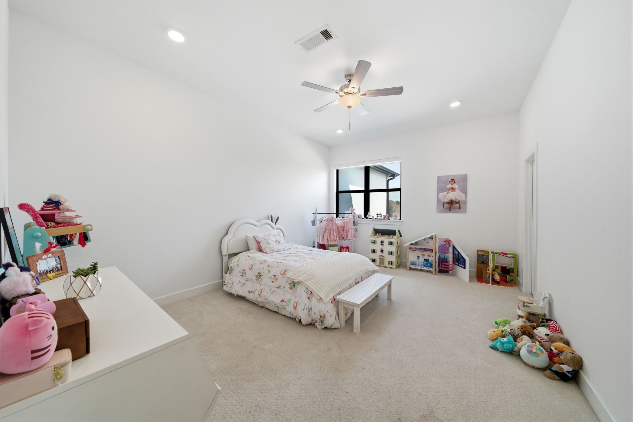 4906 Lagos Lagoon Way Spring, TX 77389 - Photo 13 of 26 a bedroom with bed and a chandelier