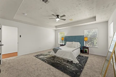 a bedroom with a large bed and a chandelier