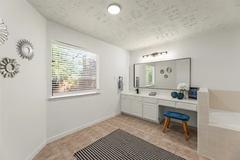 a room with furniture a rug and a window