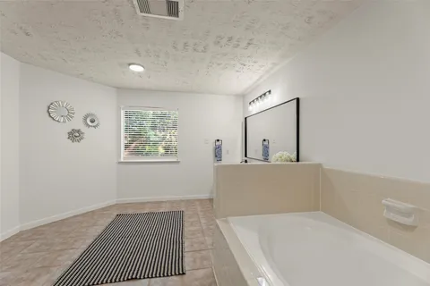 a living room with a large window and a table