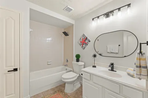 a bathroom with a sink mirror and toilet