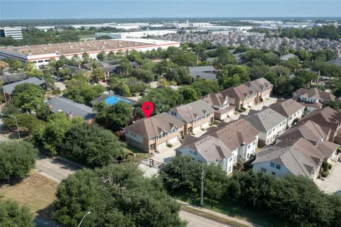 an aerial view of a house with yard swimming pool and outdoor seating
